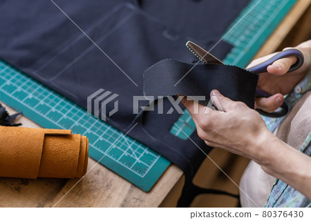 Craftsman drawing scheme lining for bag on tissue creating leatherwork at studio leather workshop Craftsman drawing scheme lining for bag on tissue creating leatherwork at studio leather workshop 80376430