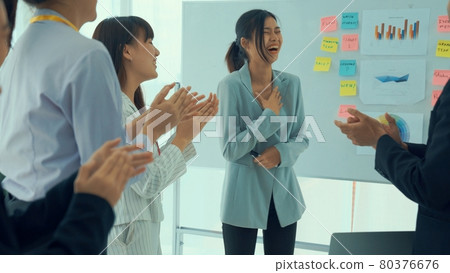 Businesswoman proficiently present work project receive celebrations from team 80376676