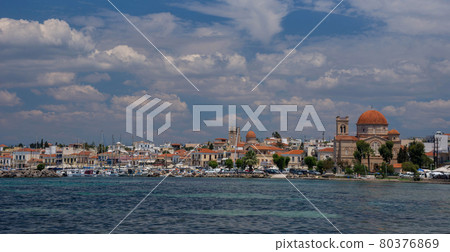 Clear waters of Mediterranean sea and a beautiful view of Aegina town in Aegina island, Saronic gulf, Greece. 80376869