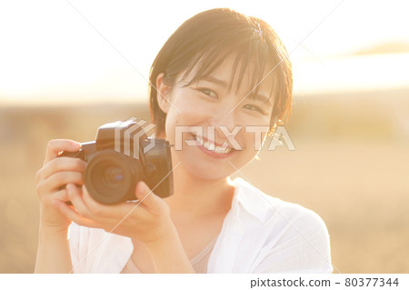 A woman taking a picture 80377344