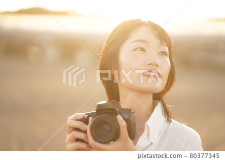A woman taking a picture 80377345