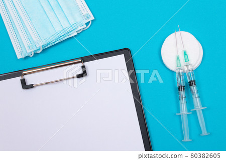 Vaccination or Revaccination Concept - Two Medical Syringe on Blue Table 80382605