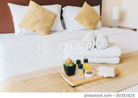 Group set of free hotel amenities (such as towels, shampoo, soap, gel etc) on the bed. Hotel amenities is something of a premium nature provided in addition to the room when renting a room. Group set of free hotel amenities (such as towels, shampoo, soap, gel etc) on the bed. Hotel amenities is something of a premium nature provided in addition to the room when renting a room. 80383828