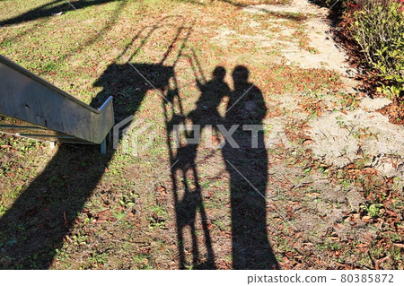 A happy child reflected on the lawn, the shadow of a happy family A happy child reflected on the lawn, the shadow of a happy family 80385872
