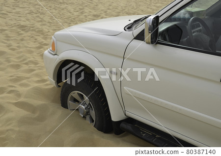Hazards of desert drive - a car stuck in the sand Hazards of desert drive - a car stuck in the sand 80387140