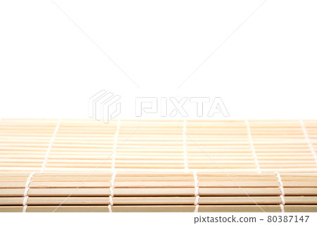 Partly rolled up shushi bamboo mat isolated on white background. Japanese kitchenware 80387147