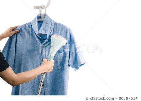 A woman ironing clothes with Steam iron A woman ironing clothes with Steam iron white background 80387614