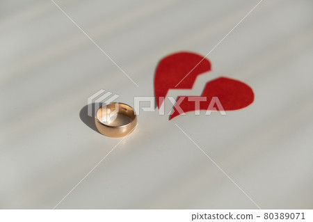 An engagement ring and a broken heart. Divorce concept. An engagement ring and a broken heart. Divorce concept. 80389071