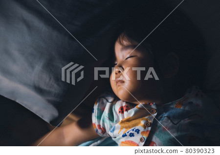 Girl sleeping in bed at night 80390323