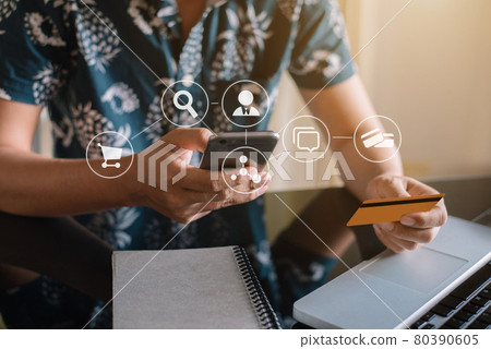 Male businessman use credit cards to conduct financial transactions through phones, tablet, and laptop at home office. Male businessman use credit cards to conduct financial transactions through phones, tablet, and laptop at home office. 80390605