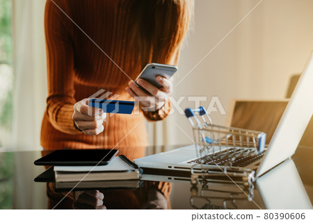 Online shopping concept, women shopping online is a form of electronic commerce from a seller over internet. Online shopping concept, women shopping online is a form of electronic commerce from a seller over internet. 80390606