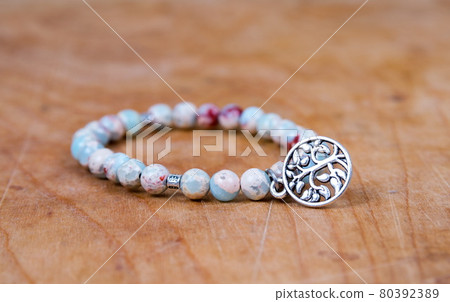 Bead bracelet on the wooden table 80392389