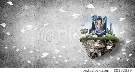 Cute boy of school age with book exploring this great world 80392829