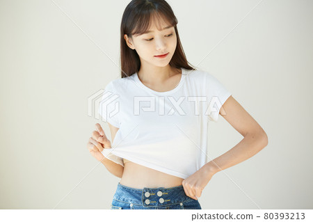Portrait of a young woman in a white T-shirt 80393213