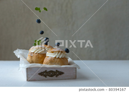 food concept - Fresh baked homemade buns on the table for breakfast Baking traditional Swedish semla bread for Throve thursday 80394167