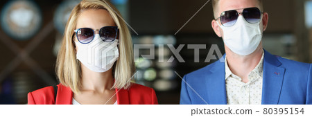 Portrait of man and woman wearing medical protective masks Portrait of man and woman wearing medical protective masks 80395154
