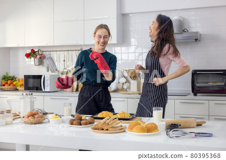 Two hearts that are overflowing with love. Full length of a lovely young couple in casual attire dancing and smiling in their kitchen at home. Two hearts that are overflowing with love. Full length of a lovely young couple in casual attire dancing and smiling in their kitchen at home. 80395368