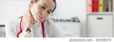 Tired doctor with cervical pain at his desk Tired doctor with cervical pain at his desk 80396073