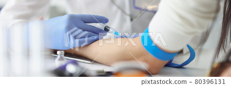 Doctor gives an intravenous injection to patient in medical office Doctor gives an intravenous injection to patient in medical office 80396131