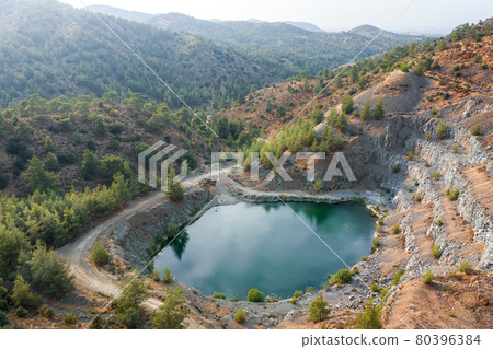 Lake in abandoned pit of basalt quarry near Machairas, Cyprus 80396384