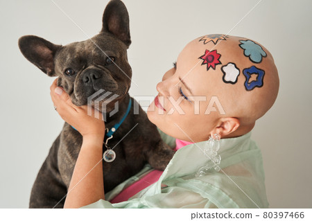Woman with creative pattern at her head hugging her lovely french bulldog while posing Woman with creative pattern at her head hugging her lovely french bulldog while posing 80397466