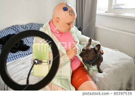 Woman asking her dog for the silence while preparing recording her video blog 80397539