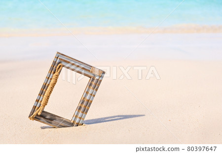 Wooden Photo frame on the tropical sea sand and the beach background with copy space 80397647