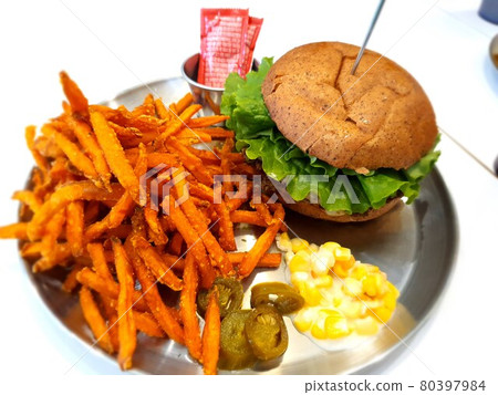 Homemade hamburger served with thick-cut, crispy fried French fries Homemade hamburger served with thick-cut, crispy fried French fries 80397984