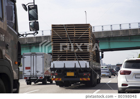 A truck loaded with wooden pallets 80398048