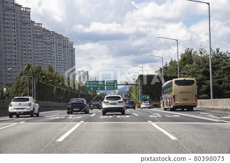 A vehicle driving on a road with a lot of traffic 80398073