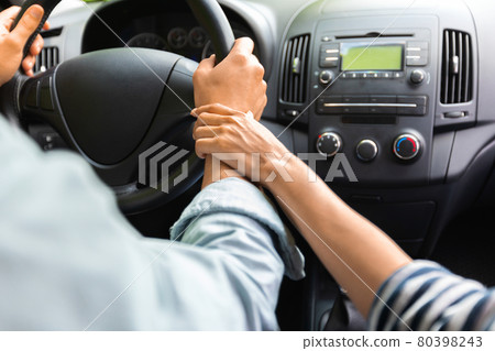 Unrecognizable lady touching husband driving car hand 80398243