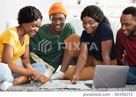 Excited african american friends planning summer trip together 80398255