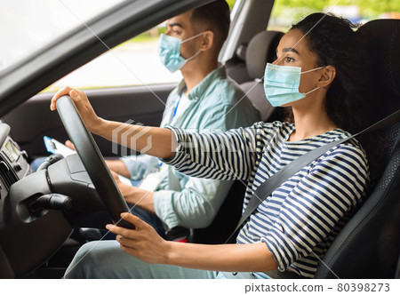 Brunette woman learning parking at driving school while pandemic 80398273