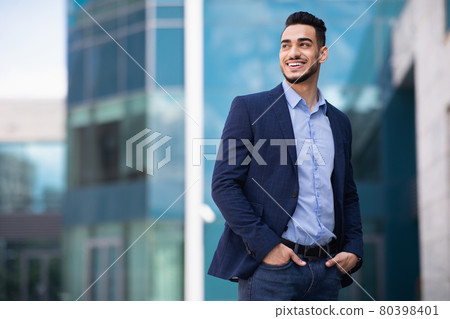 Young arab man standing by business center 80398401