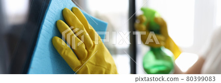 Man washing window in protective gloves closeup Man washing window in protective gloves closeup 80399083