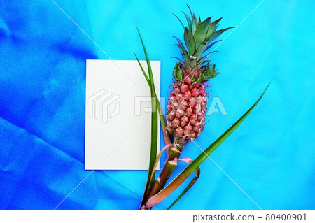 Rectangle invitation mockup decorated with mini pineapple on blue cloth background Rectangle invitation mockup decorated with mini pineapple on blue cloth background 80400901