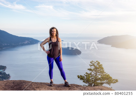 Adventurous Woman Hiking on top of Mountain Landscape Adventurous Woman Hiking on top of Mountain Landscape 80401255