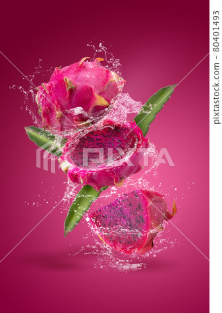 Water splashing on Ripe pitahaya fruit or dragon fruit with half isolated on red background 80401493