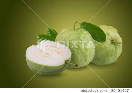 Green guava and half and leaves on a green background Green guava and half and leaves on a green background 80401497