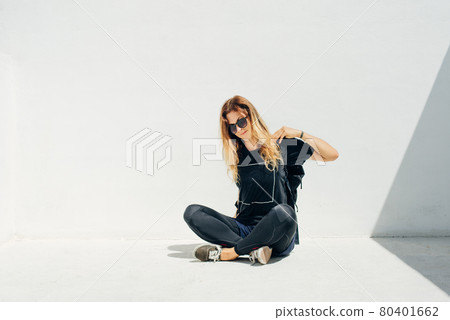 girl in sunglasses and in black with a backpack on a white background girl in sunglasses and in black with a backpack on a white background 80401662