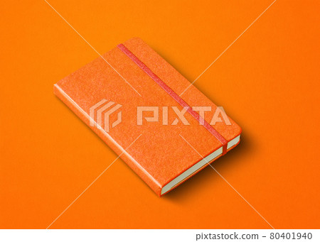 Orange closed notebook isolated on color background 80401940