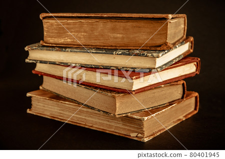 Stack of old books on black background Stack of old books on black background 80401945