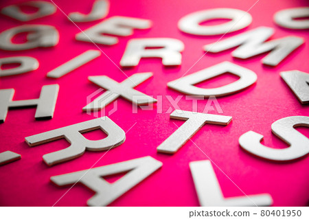 Mixed letters pile close up view photo. Pink background 80401950