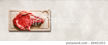 Beef prime rib and wooden cutting board isolated on white concrete background. Horizontal banner Beef prime rib and wooden cutting board isolated on white concrete background. Horizontal banner 80401953