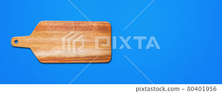 Wooden cutting board isolated on blue. Horizontal banner Wooden cutting board isolated on blue. Horizontal banner 80401956