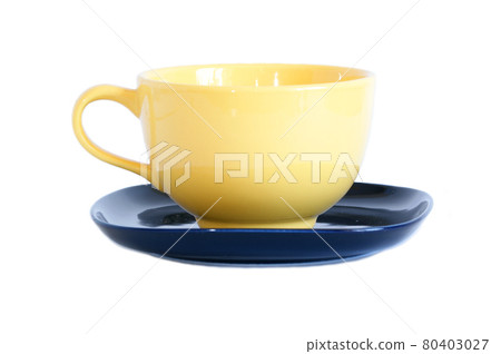 Large yellow cup and black saucer isolated on white Large yellow cup and black saucer isolated on white 80403027