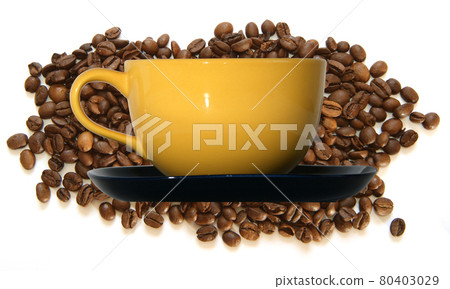 Large yellow cup and black saucer on the background of coffee beans, isolated on white Large yellow cup and black saucer on the background of coffee beans, isolated on white 80403029