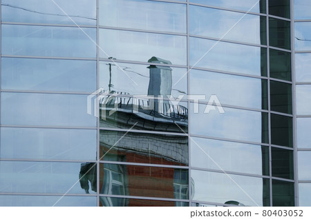 Reflection of clouds, blue sky and the other buildings in the glass windows of office building Reflection of clouds, blue sky and the other buildings in the glass windows of office building 80403052