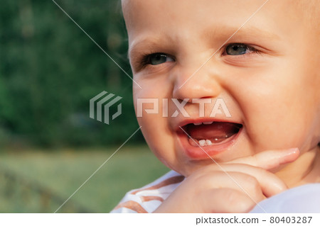 Little boy looks over his mother's shoulder. 80403287