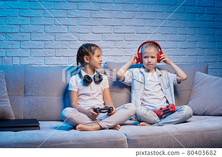 children playing video game with game console children playing video game with game console 80403682